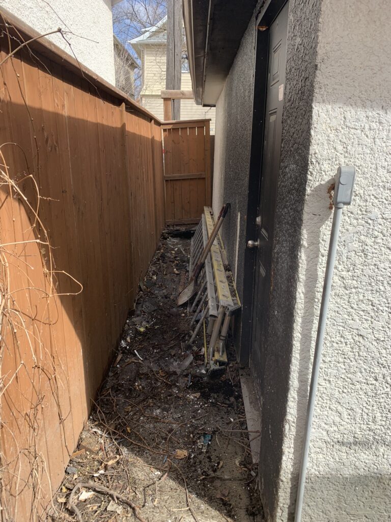 A clean nook between a garage and a fence